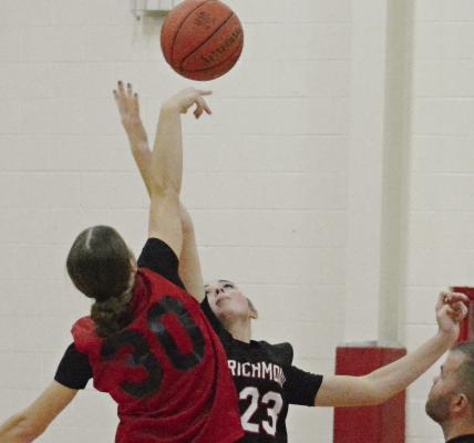 RICHMOND JUNIOR Emma Hash reaches for the opening tipoff during the Spartans’ jamboree scrimmage with Lawson.