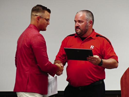 HALL OF FAMER Kyle Carroll (left) gets a handshake from Brandon Quick, former Richmond coach and current Richmond High School principal.