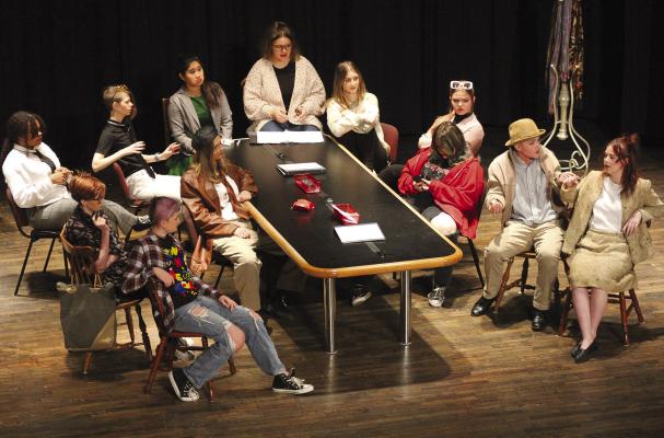 RHS STUDENTS Marlie McAdams (starting at left around the prop table), Serenity Taylor, Kara Clayton, Jazlin Jameson, Raigan Braley, Aspen Erskine, Eve Tompkins, Hannah Hayes, Alaina England, Rori Linder, Jazspher Ulleberg and Ally Fisher are the “12 Incompetent Jurors” in the play. SOPHIA BALES | Staff