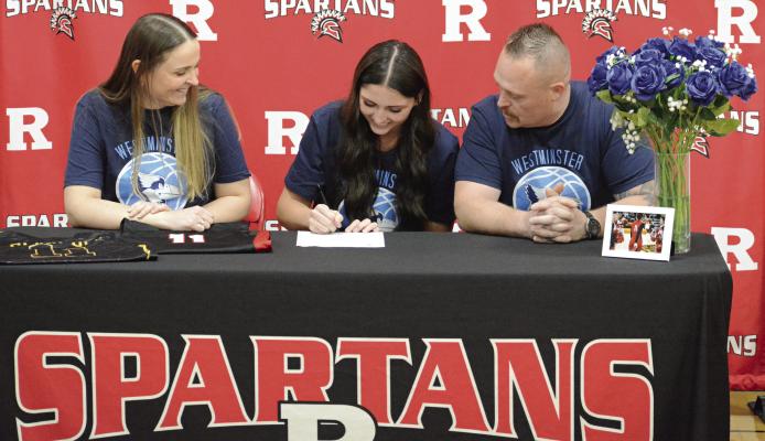 RICHMOND SENIOR Candiace Claypole literally gets her flowers on her signing day. Watching her formally express her intent to play women’s basketball at Westminster College in Fulton are parents Charmain (left) and Nathan Claypole. Story on page 12. SHAWN RONEY | Staff