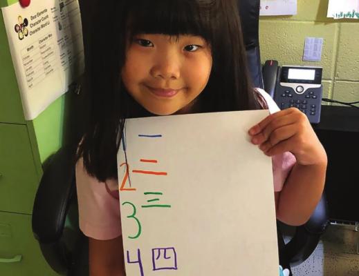 ALINA YAN helps teach numbers in Chinese.