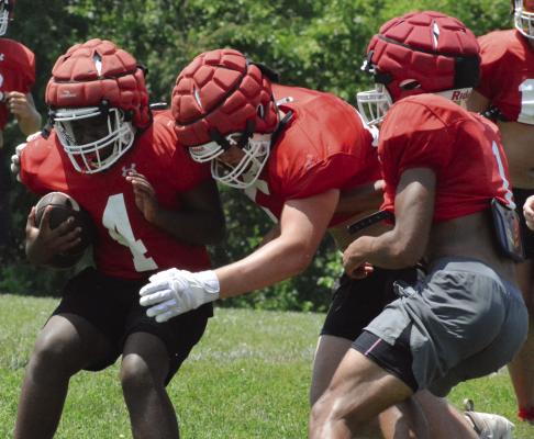 SAVION WEBB (left), an incoming freshman, braces for contact as Richmond’s offensive and defensive units scrimmage near the end of a session of team camp. Camp coverage continues below. SHAWN RONEY | Staff