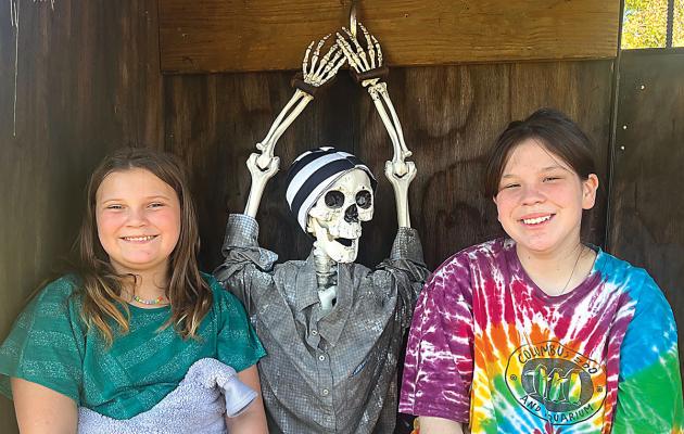 SOPHIA BALES | Staff TOP, FROM LEFT: Ireland Orr, Allisha Bales and “friend” complete the Escape Room On Wheels with Inside Out Escape Entertainment from Excelsior Springs that’s feautred at the sheriff's domestic violence event.