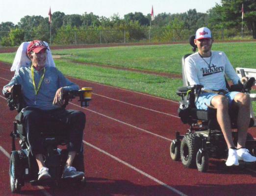 RACING around the track, Mark Johnson and Tony Vick jam out to Free’s “All Right Now.” TARA ALTIS | Staff