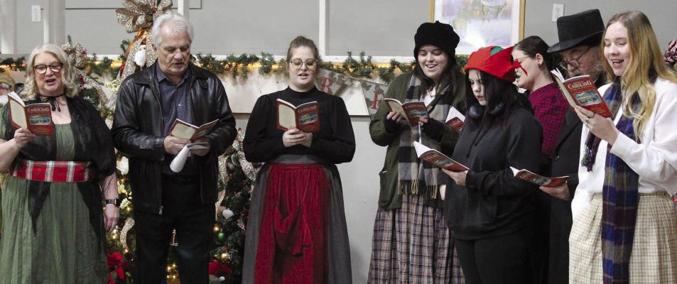 CAST MEMBERS of “Scrooge” sing Christmas carols during the event at the Eagleton Center.