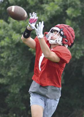 DYSON HENDRIX follows the football into his hands as he and other Richmond skill position players drill over passing routes Tuesday on the Spartans’ practice field. SHAWN RONEY | Staff