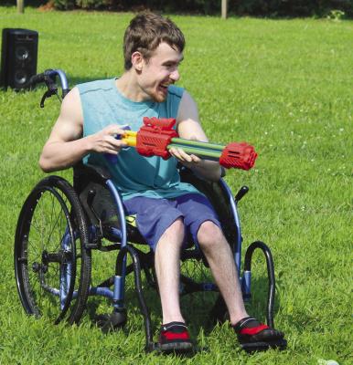 TYLER MEFFORD engages in a water gun fight.