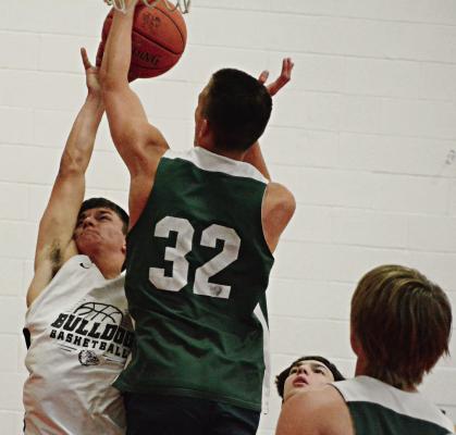 AMID A sea of green jerseys, Hardin-Central’s Kameron Pugh attempts a first-half shot Monday against Polo in the Lawson Middle School gym. SHAWN RONEY | Staff