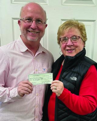 BETA TAU TREASURER Judy Salter presents a donation to Salvation Army Director Phil Powers (left). Submitted
