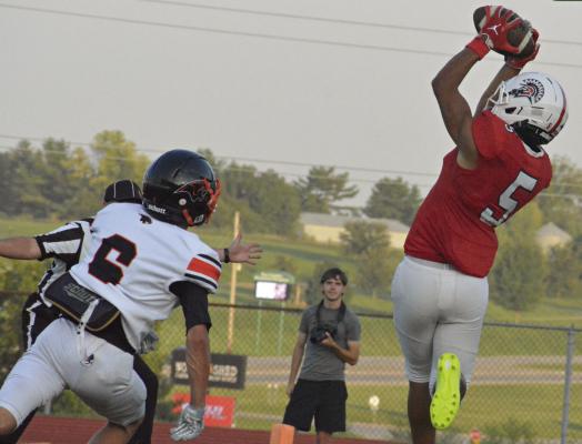 RICHMOND SENIOR wide receiver Malikiah Tharp (right) snags a touchdown pass over Oak Grove’s Ethan Phelps. SHAWN RONEY | Staff