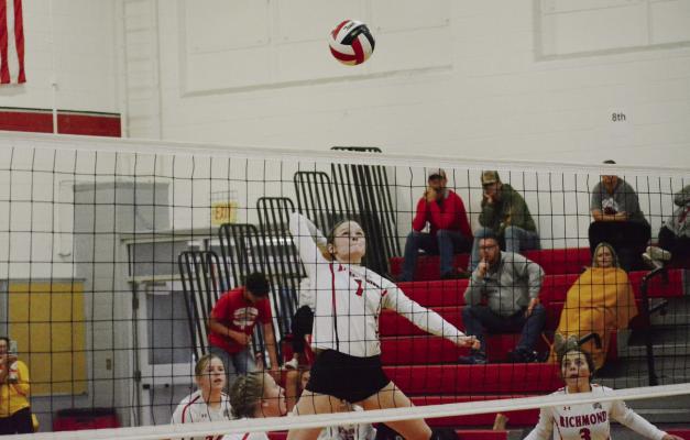 WITH SPECTATORS and her teammates watching, senior Kelly Jaggars leaps high to attempt a kill shot during Richmond’s third-place match with Brookfield Oct. 1 in the Carrollton Tournament. SHAWN RONEY | Staff