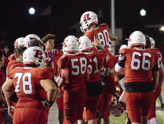 SETH JAMES (No. 80) gets treated as if he has kicked a game-winner shortly after booting an extra point for Richmond during the second half of the Spartans’ 56-7 Week 6 homecoming rout of Carrollton in varsity 11-man football. SHAWN RONEY | Staff