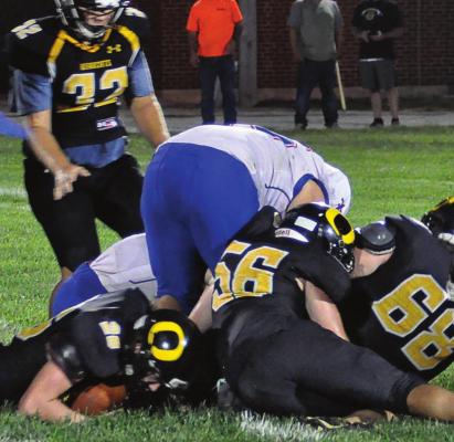 TO THE left of a pile of Bearcats and Saints, Orrick senior Chanler Woods falls on a third-quarter fumble by St. Paul Lutheran of Concordia to help the Bearcats stage a 26-20 comeback victory Aug. 27 at Simmons Field. SHAWN RONEY | Staff
