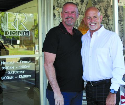 EMBARKING ON A new journey at a later stage in life, Randy Wrisinger (right), stands with his husband, Richard Wilson, on opening day of his new business. SHARON DONAT | Staff
