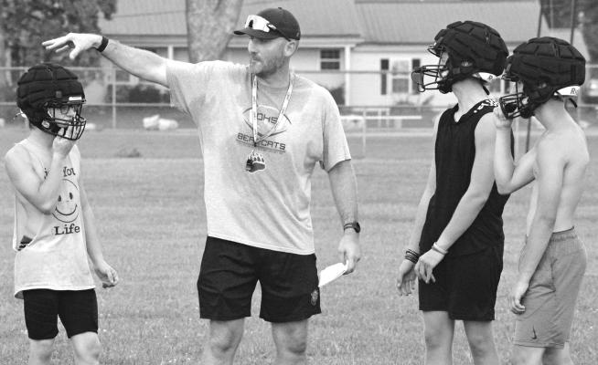 AARON RODENBERG (center) settles into his job of leading Orrick’s varsity 8-man football program. SHAWN RONEY | Staff