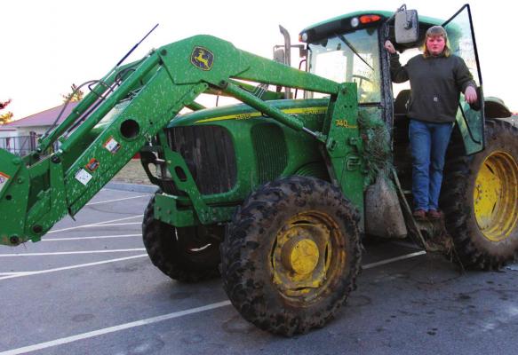 RICHMOND High School FFA student Corbin Calvert, 17, climbs down from the cab of the tractor he drives to school.