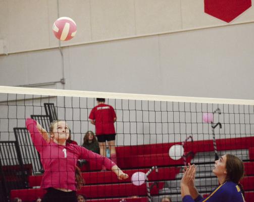 SPORTING HER dark pink jersey, Richmond senior Kelly Jaggars rears back to hit Tuesday night against visiting Lafayette County of Higginsville.