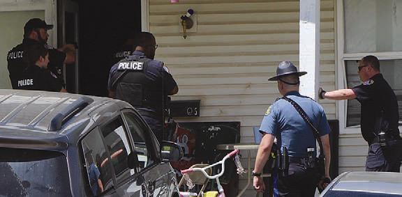 LAW ENFORCEMENT officers secure the perimeter around a Richmond residence during a police standoff. SHARON DONAT | Staff