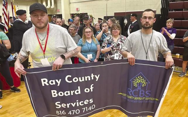 RAY COUNTY ATHLETES Caleb Shockey (left) and Cody Stevens escort the 10 other Special Olympic participants to the indoor games. Submitted