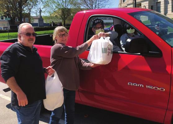 THE RAY COUNTY 911 Emergency Services Board thanks 911 telecommunicators/dispatchers with a meal. From left are board members Robert McClellan and Becky McClellan, who deliver a meal to the day shift telecommunicators/dispatchers. Receiving the meals curbside are Director Kim Davis and Assistant Director Dan Collins.