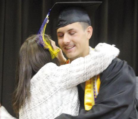 PARKER FLOYD embraces his mother, Board of Education member Mandy Floyd, after receiving his diploma during Orrick High School commencement ceremonies. MIRANDA JAMISON | Staff