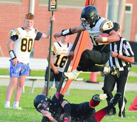SENIOR JEFF ROHDE, shown hurdling a Northland Christian defensive player during the Bearcats’ Aug. 23 preseason jamboree, is among 30 Orrick High School students out for 8-man football. SHAWN RONEY | Staff