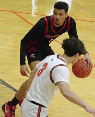 RICHMOND JUNIOR Brice Dome dribbles near the top of the key, with Oak Grove senior Maddox Carillo nearby.