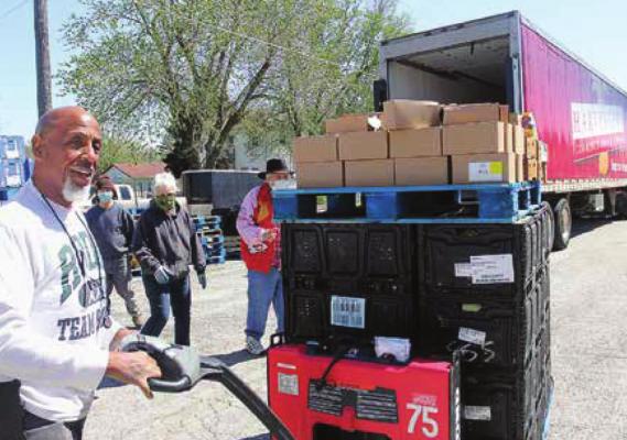 A DRIVER for the Harvesters Community Food Network in Kansas City, Frank Gray, unloads food from the trailer onto the lot of the Salvation Army Family Store in Richmond. J.C. VENTIMIGLIA | Staff