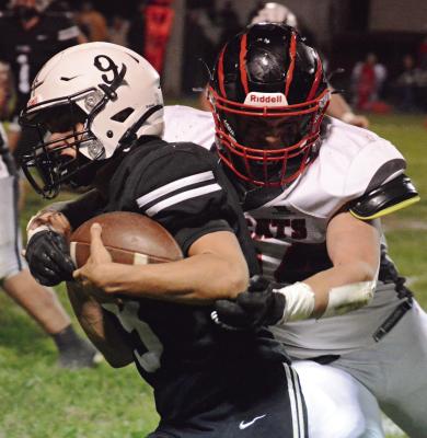 WITH THE FOOTBALL ffirmly tucked against his body, Brody Fifer fights for yardage as he carries for Norborne Hardin-Central in Week 8 varsity action at Hardin-Central. SHAWN RONEY | Staff