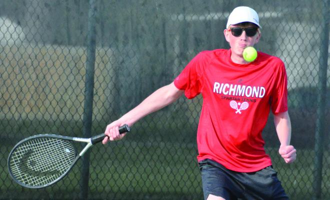 SENIOR DREW ISAACSON looks to hit a return forehand shot Tuesday at Higginsville. SHAWN RONEY | Staff