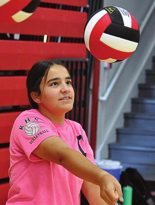 NEW RICHMOND varsity volleyball coach Crystal Turner is a hit with Sarah Brungardt, who practices her bumping. SHAWN RONEY | Staff