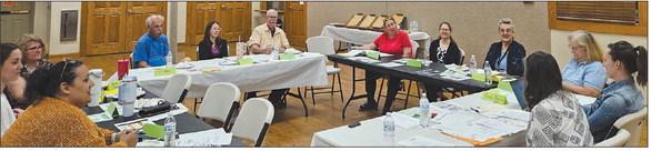 RAY COUNTY COALITION members discuss supply collection, volunteer needs and event logistics for the upcoming back-toschool resource fair. MIRANDA JAMISON | Staff