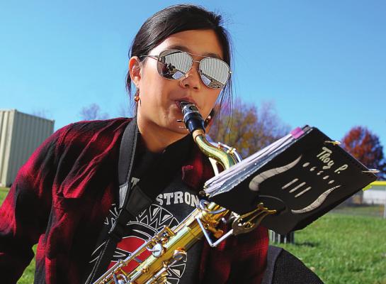 FOR THE VETERANS DAY performance at the Veterans Building, sophomore Aspen Erskine plays the tenor sax. She says getting back to class to work with each other will help band members improve. J.C. VENTIMIGLIA | Staff