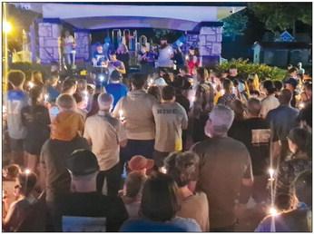 THE LAWSON community holds their candles, lit in remembrance of the student who lost their life and prays for the recovery of the student who was injured. MIRANDA JAMISON | Staff
