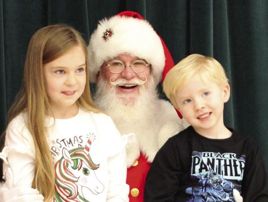 RYANN MADGET (from left), Santa and Reise Madget spend time with each other during breakfast with Santa event at Richmond Middle School. SOPHIA BALES | Staff