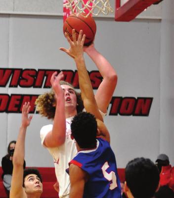 RICHMOND SOPHOMORE Jack Gogue rises above the crowd of Lexington defenders.
