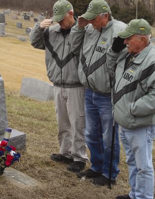 WAYNE WALTON (from left), Bruce Biggs and Richard Blair salute Forrest Dickey’s grave in silent tribute to a life lost in battle. SHARON DONAT | Staff