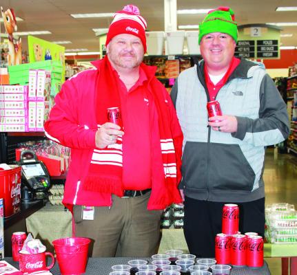 Coca-Cola representatives Mike McCarter (left) and Eric Caldwell (right) handled the soda tasting area while conducting a raffle for Ray County customers.