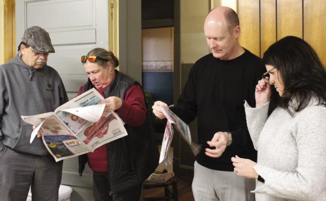 RESIDENT DARROLL RUARK (from left), Chamber Director Jayne Taylor, Richmond School District Superintendent Dr. Bryan Copple and his wife, Rhonda, read the Town and Country Leader’s Love Local Legends section highlighting nominees and winners during the recognition ceremony. MIRANDA JAMISON | Staff