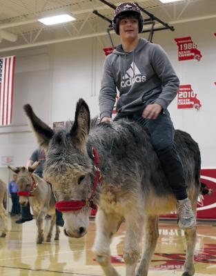 RHS STUDENT RICKY RUSS entertains the crowd as he rides a donkey and plays basketball. Submitted