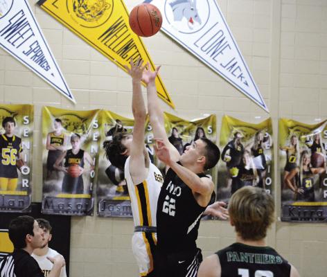 JONATHON HARRIS and Polo junior Hunter McGee leap for the opening tipoff.