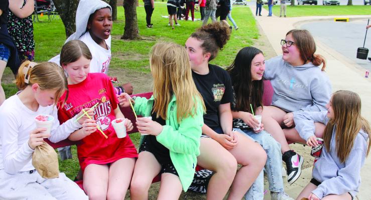 PEYTON FISK (from left), Adelia Desmond, Savion Webb, Autumn Stevens, Olivia McCroskie, Brayliegh Martinez, Maci Torrey and Leighton Hoyle chat amongst themselves as they enjoy the middle school festivities for the MAP testing celebration. SOPHIA BALES | Staff