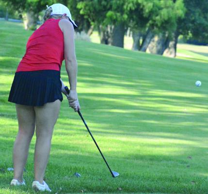 SENIOR KAROLINE DOOLEY keeps her head down as she attempts a chip shot during Richmond’s quadrangular with Lawson, Excelsior Springs and Norborne. SHAWN RONEY | Staff