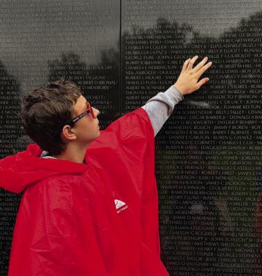 GABRIEL REED SEARCHES for the name of a relative on the Vietnam Veterans Memorial during Richmond Middle School’s 37th annual Washington, D.C., trip. Story on page 7. Submitted