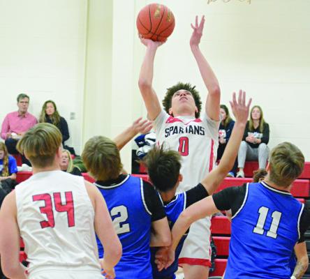 RICHMOND SENIOR Gabe Johnson (center) draws a crowd as he attempts a first-half shot. SHAWN RONEY | Staff