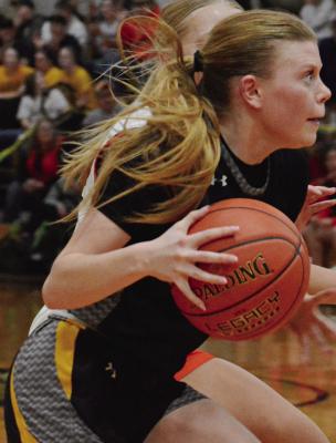 ADDISON CHAPMAN stares intently down the court as she dribbles during Orrick’s Class 1 District 13 Tournament semifinals with Hardin-Central in girls basketball. The 62-38 defeat Feb. 25 at Norborne ended the Orrick girls’ season at 8-20. It also was the final game in an Orrick basketball uniform for Chapman, the lone senior listed on Orrick’s girls varsity roster.