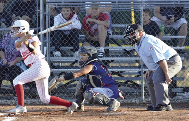 MAYA GRIFFIN (left) swings at a pitch during Richmond’s recent varsity softball meeting with visiting Lexington at Southview Park. SHAWN RONEY | Staff