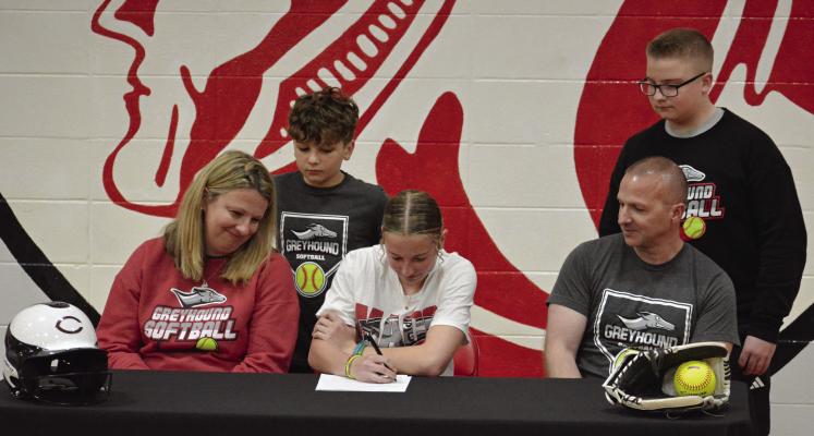 RICHMOND SENIOR Sydney Appleberry signs her letter of intent March 15 in her high school gym to play softball for and study at Moberly Area Community College as members of her family watch. Also pictured are (from left), front row, parents Cody and Brian Appleberry; second row, brothers Bryson and Hunter Appleberry. SHAWN RONEY | Staff