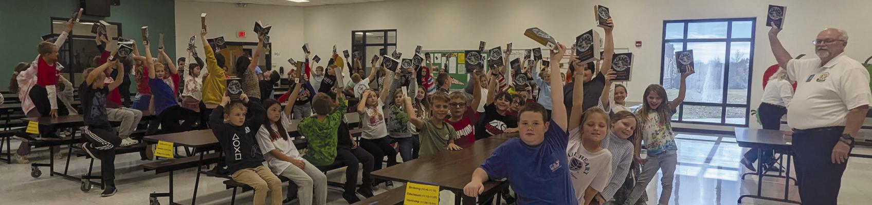 KIWANIAN BILL DOOLEY celebrates with Richmond third-graders after the Kiwanis Club presented dictionaries to the students. Submitted