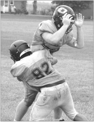 GABRIEL GRAVES (No. 82) and Tucker Greer work on tackling drills Monday on the Orrick practice field. SHAWN RONEY | Staff